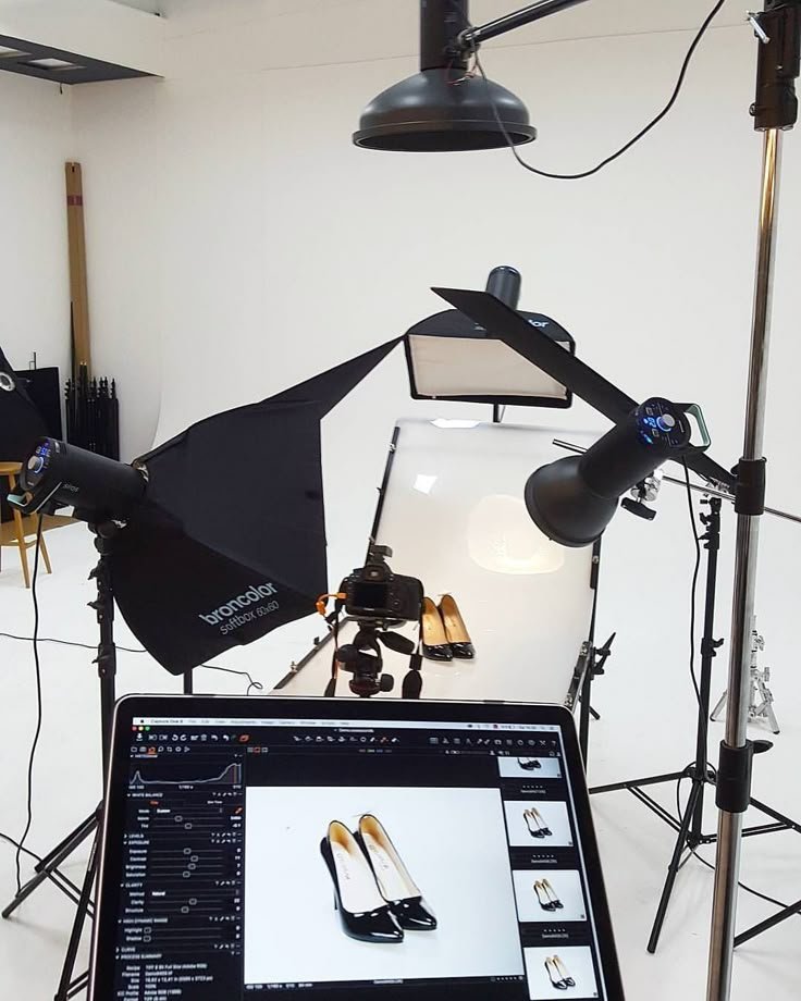 A photo studio featuring a laptop and lighting equipment, ideal for product photography tips and setup.